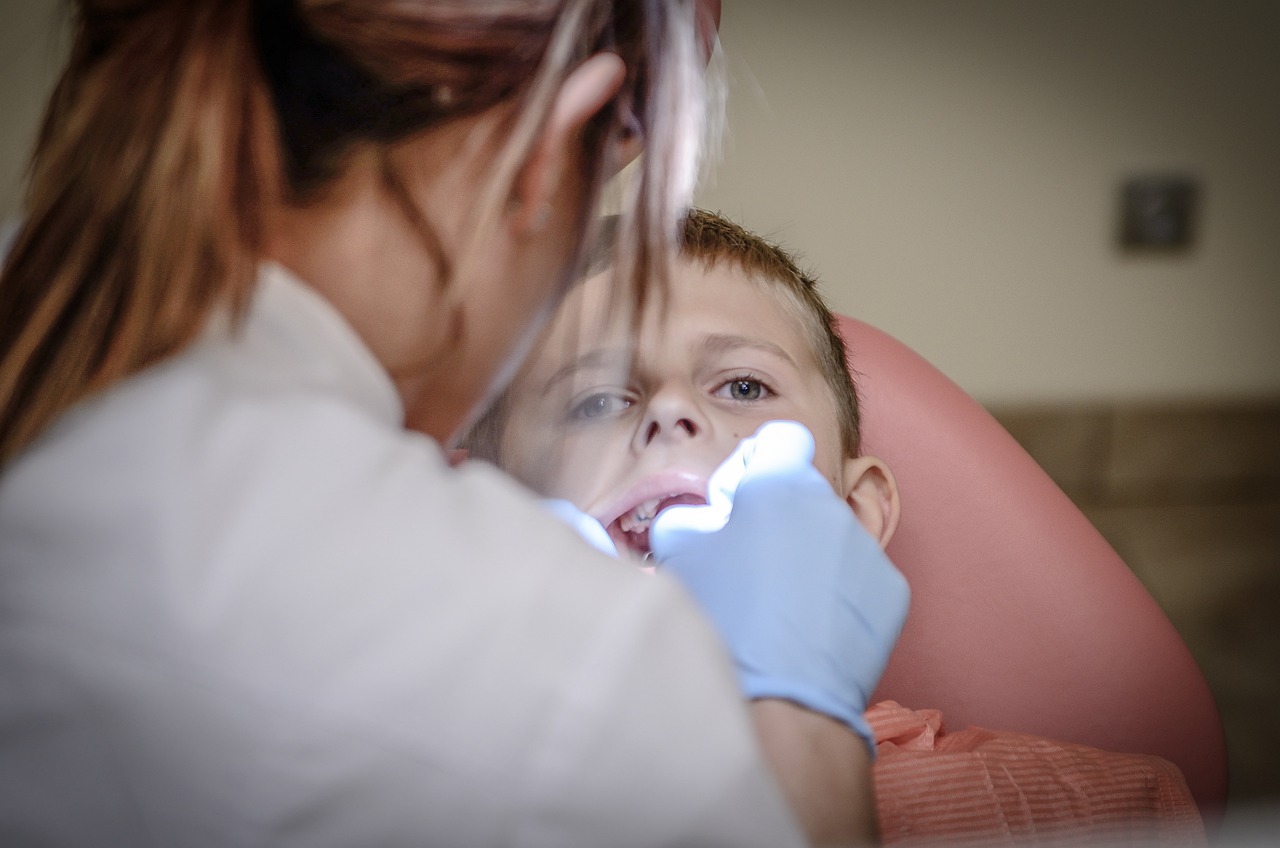 boy getting teeth cleaned by dentist
